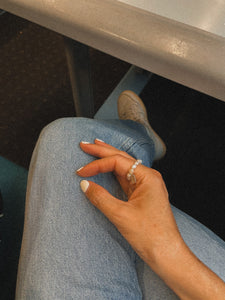woman wearing pearl ring on right hand