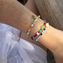 Load image into Gallery viewer, Close-up of a wrist wearing colorful beaded bracelets with a light background

