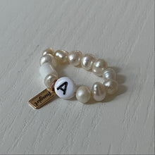 Load image into Gallery viewer, Freshwater pearl stretch ring with letter A bead and Fangirl Unauthorised tag
