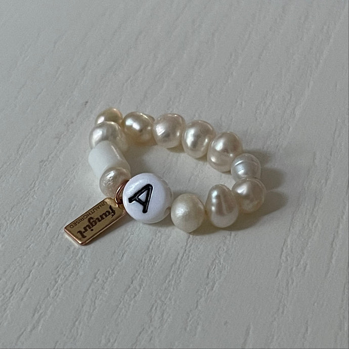 Freshwater pearl stretch ring with letter A bead and Fangirl Unauthorised tag