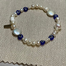 Load image into Gallery viewer, Freshwater pearl and glass evil eye bead stretch bracelet with signature Fangirl Unauthorised tag
