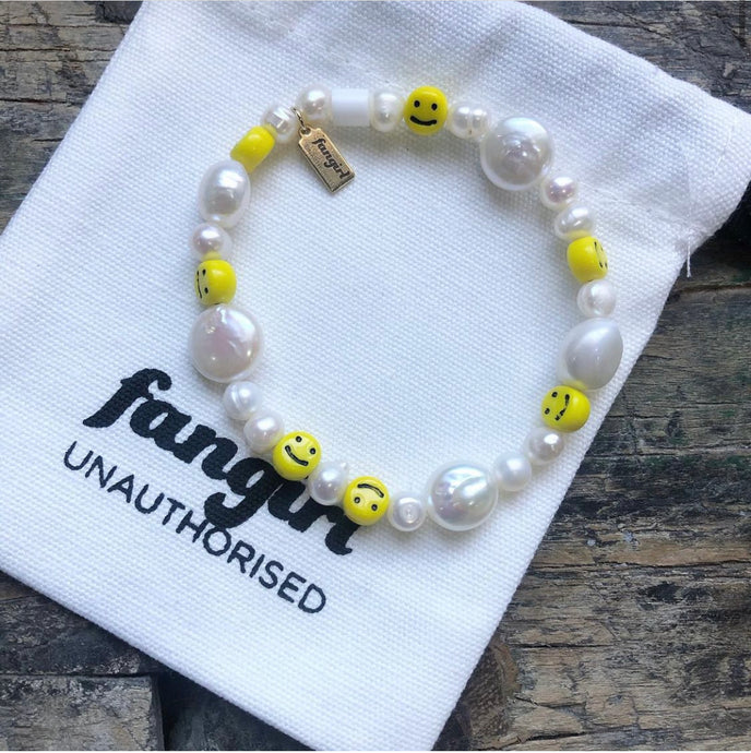 Pearl and smiley face stretch bracelet with Fangirl Unauthorised bag